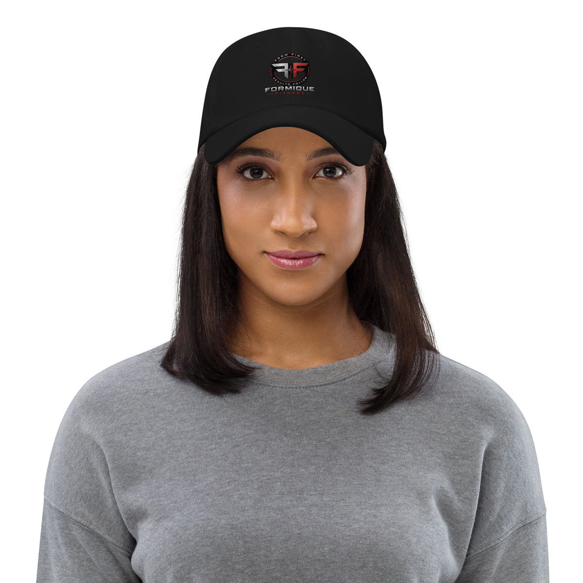 Woman wearing black Formique Fitness dad hat with low profile, curved visor, and embroidered logo. Unstructured 6-panel design.