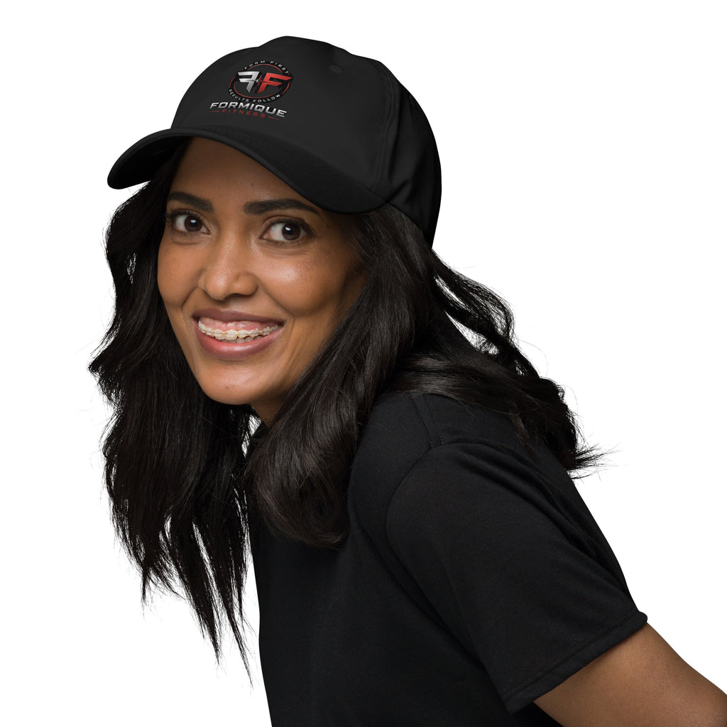 Woman wearing a black Formique Fitness dad hat featuring a low profile, curved visor, and embroidered logo.