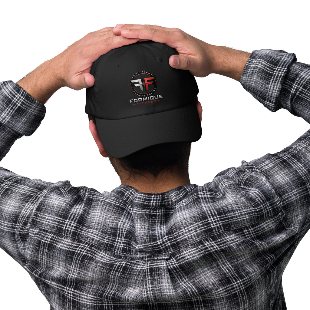 Back view of a man wearing a black Formique Fitness low-profile dad hat with embroidered logo and curved visor.