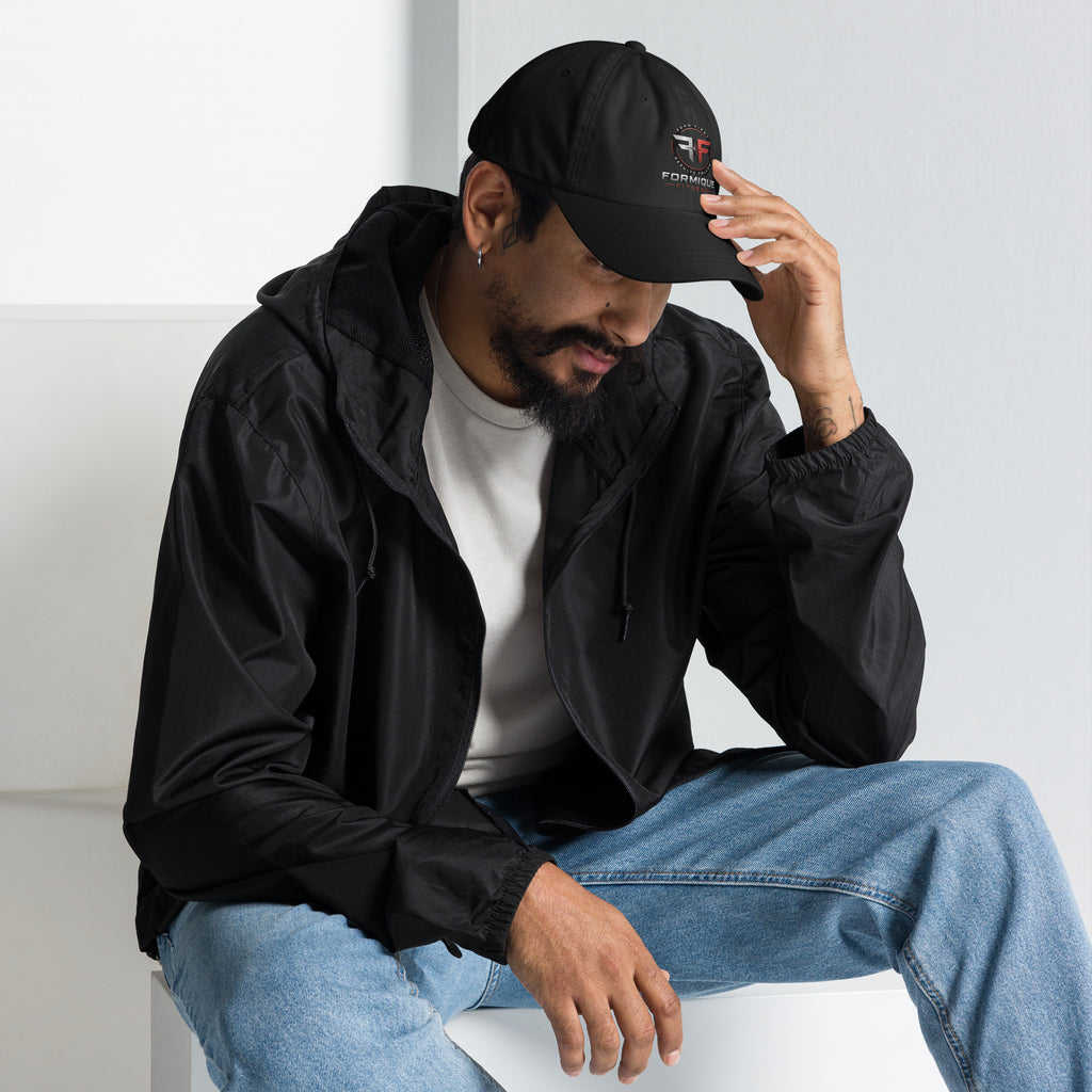 Man wearing a black Formique Fitness unstructured dad hat with low profile, curved visor, and embroidered logo.